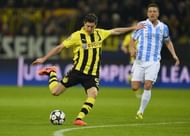 Dortmund striker Robert Lewandowski (L) shoots during their Champions League match against Dortmund on April 9, 2013